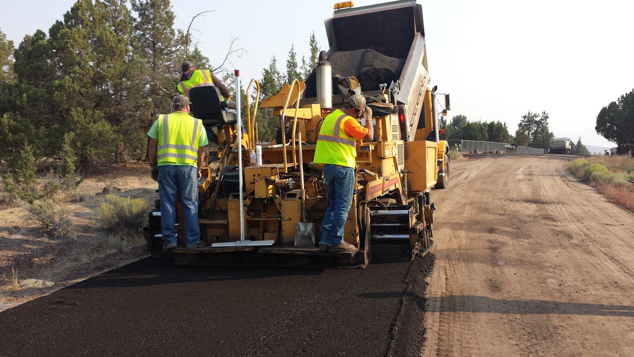 Crafting Captivating Headlines: Your awesome post title goes here Workers paving a road in Redmond, Oregon with heavy equipment.